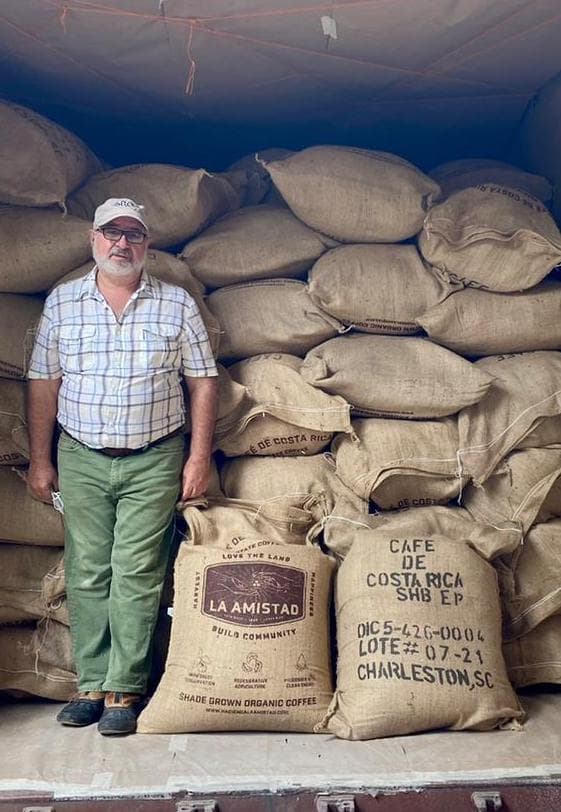 Roberto standing at the coffee farm